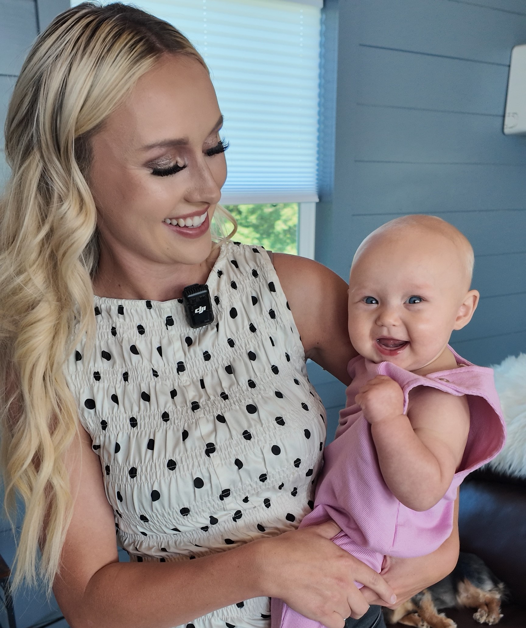 Photo of Ashlee and her baby Libby smiling in their living room