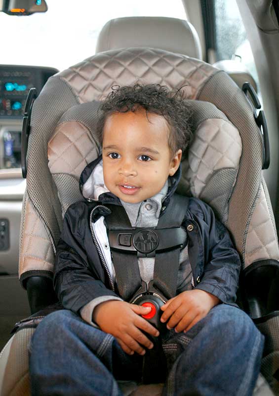 Baby properly strapped in to rear-facing seat.
