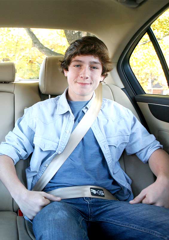 Older child displaying the proper way to use a seat belt.