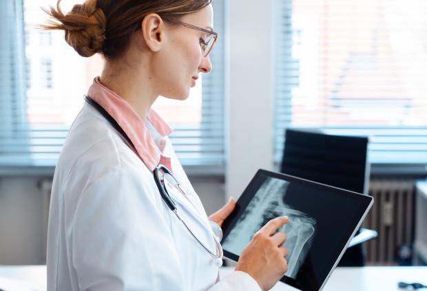 A Doctor reviews a shoulder x-ray image on her tablet