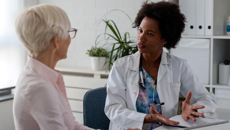 Doctor talks to adult patient