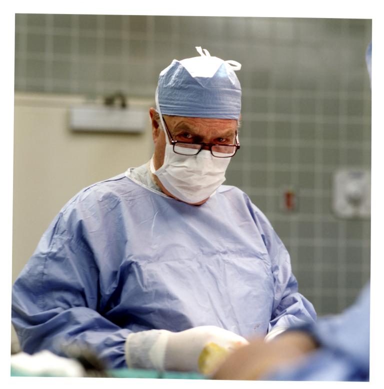 Archival photo of Dr. Thompson in the operating room