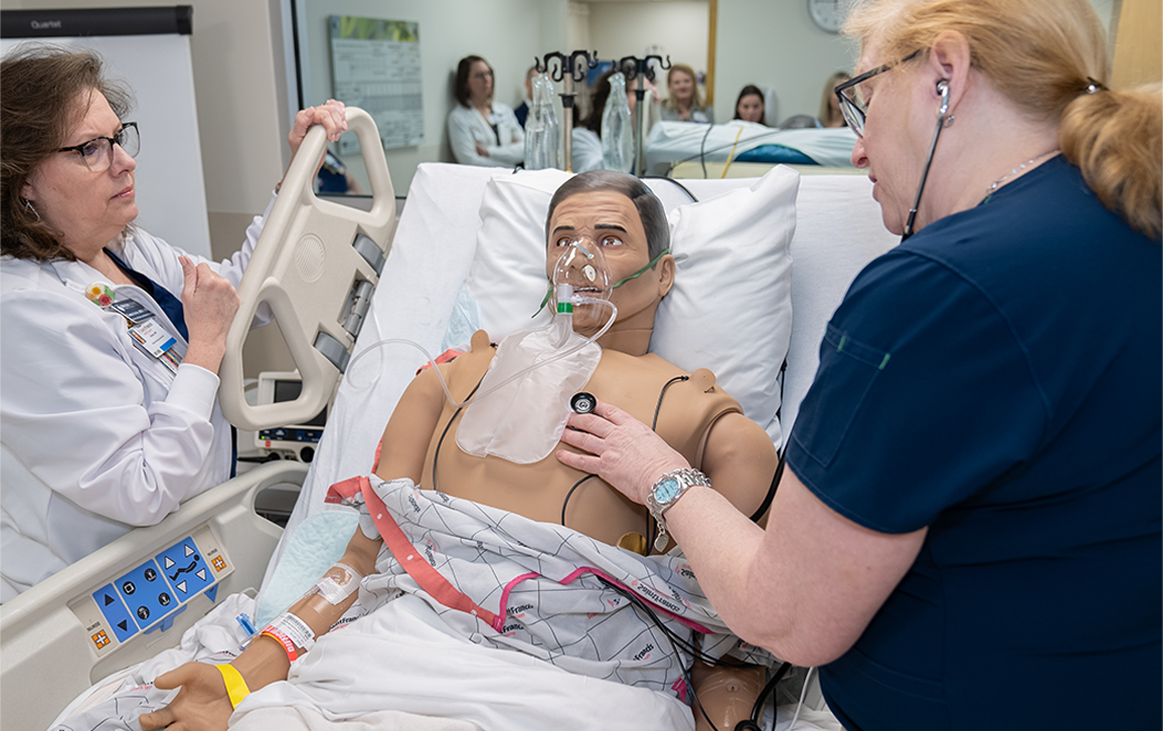 Woman using a stethoscope on a dummy