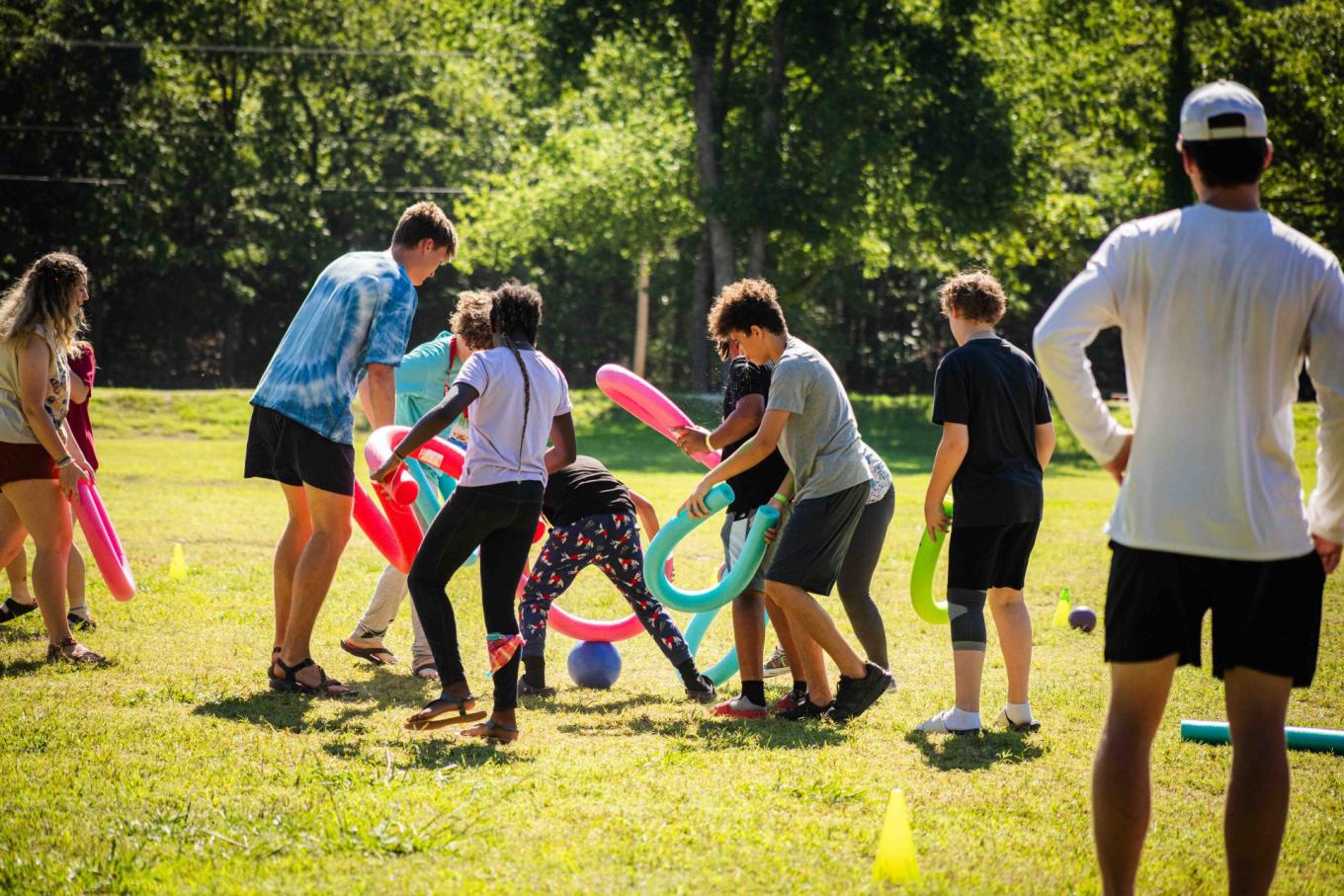 Kids playing with pool noodles