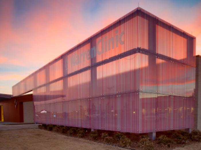 Warren Clinic Tulsa Hills exterior view against a beautiful pink sunset