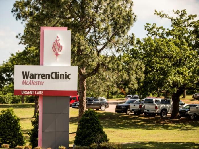 Exterior view of Warren Clinic McAlester with trees and clinic sign in foreground