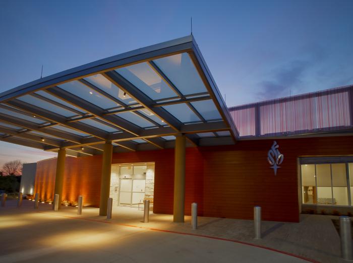 Warren Clinic Tulsa Hills exterior view of main entrance at dusk