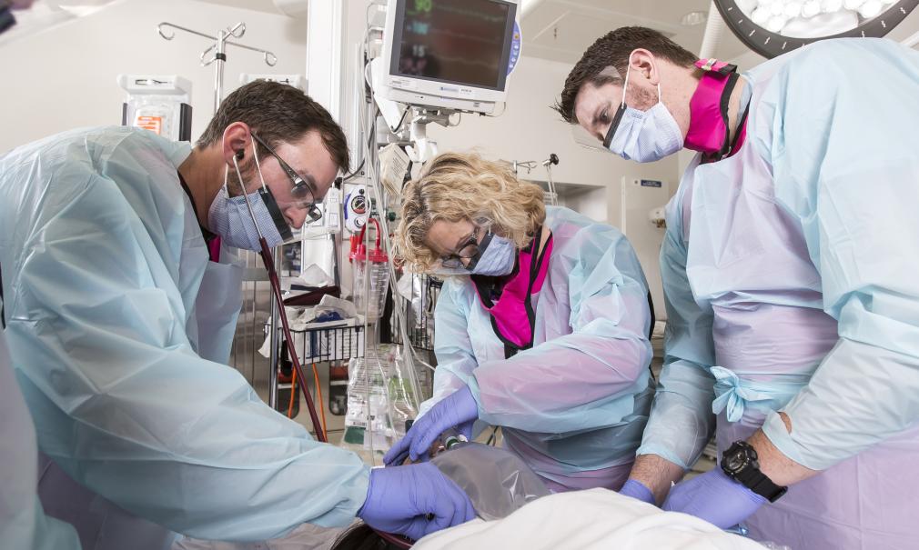 healthcare workers stabelizing a patient in a trauma center, emergency room.