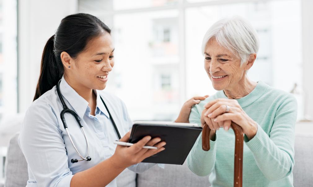 A doctor reviews good test results with an elder female patient