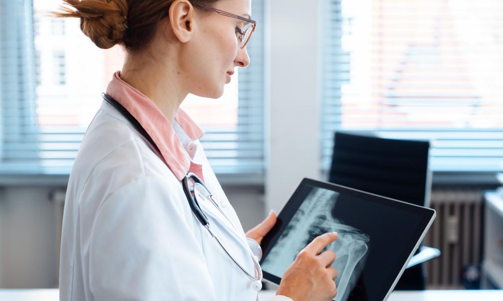 A Doctor reviews a shoulder x-ray image on her tablet