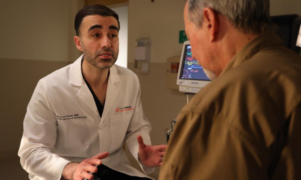 Doctor Fazel explains a procedure to an adult patient in clinic