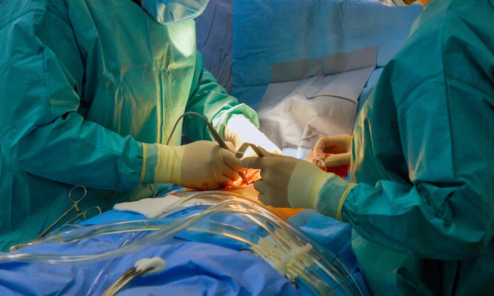 Surgical team performs open heart surgery in hospital operating room