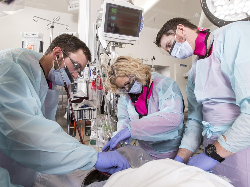 healthcare workers stabelizing a patient in a trauma center, emergency room.