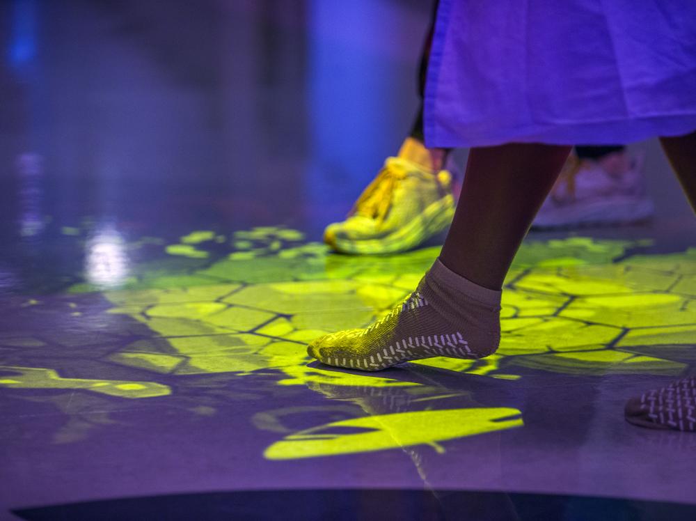 A Saint Francis patient's foot wearing a sock, tapping the floor