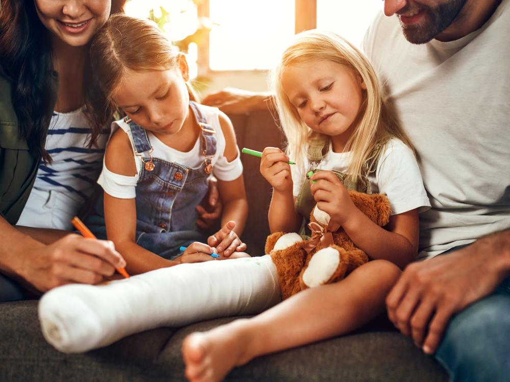 happy family decorates child's leg cast