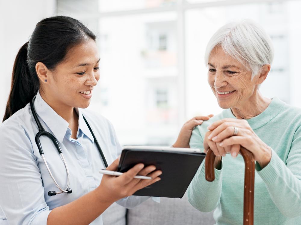 A doctor reviews good test results with an elder female patient