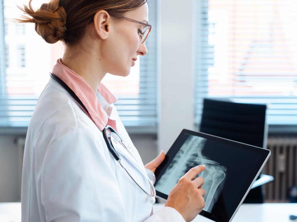 A Doctor reviews a shoulder x-ray image on her tablet