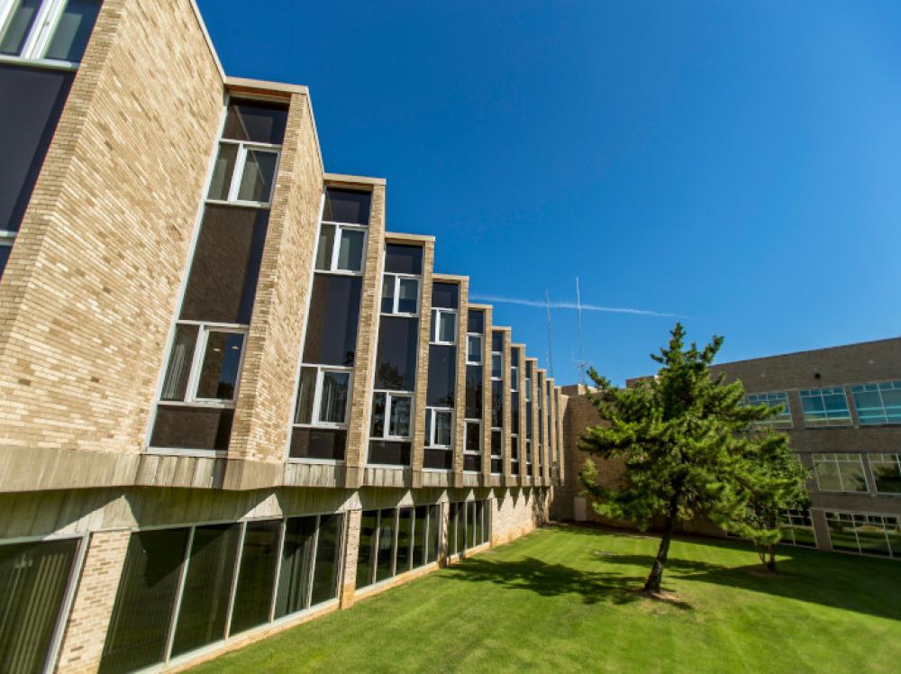 Exterior view of Saint Francis Muskogee Cancer Center with green grass on a sunny day