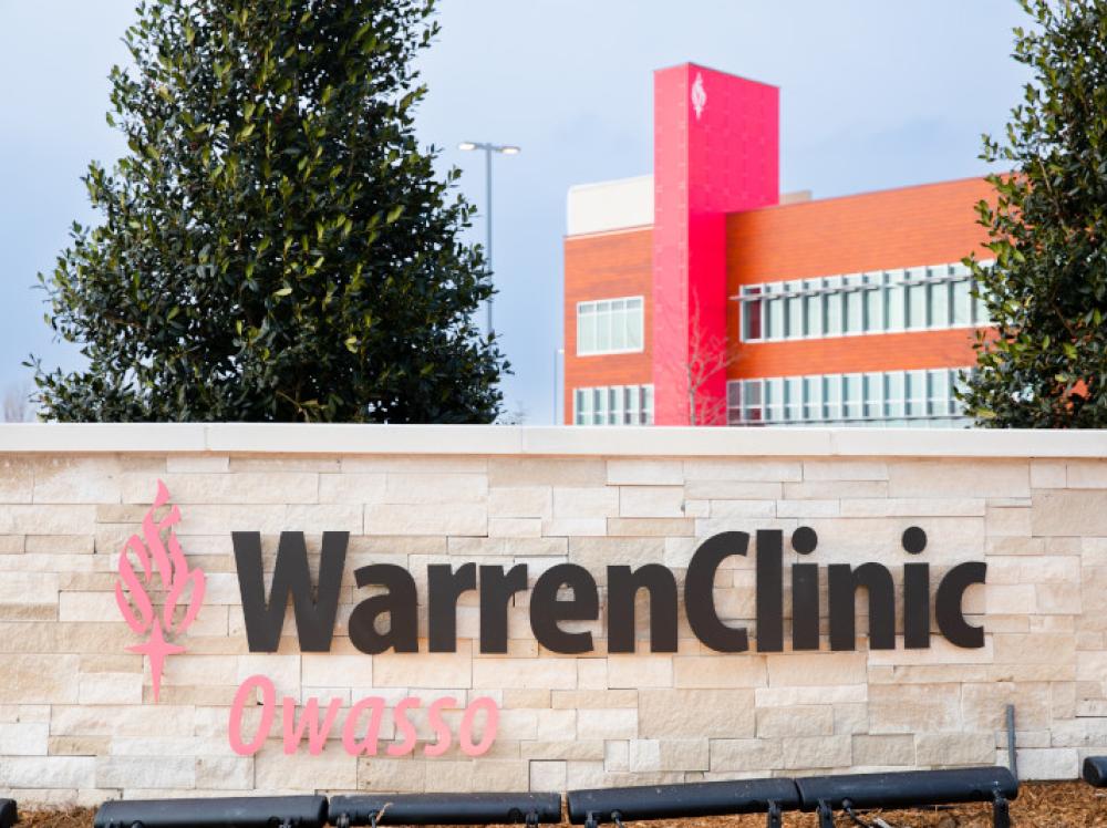 Exterior view of Warren Clinic Owasso with large sign in foreground