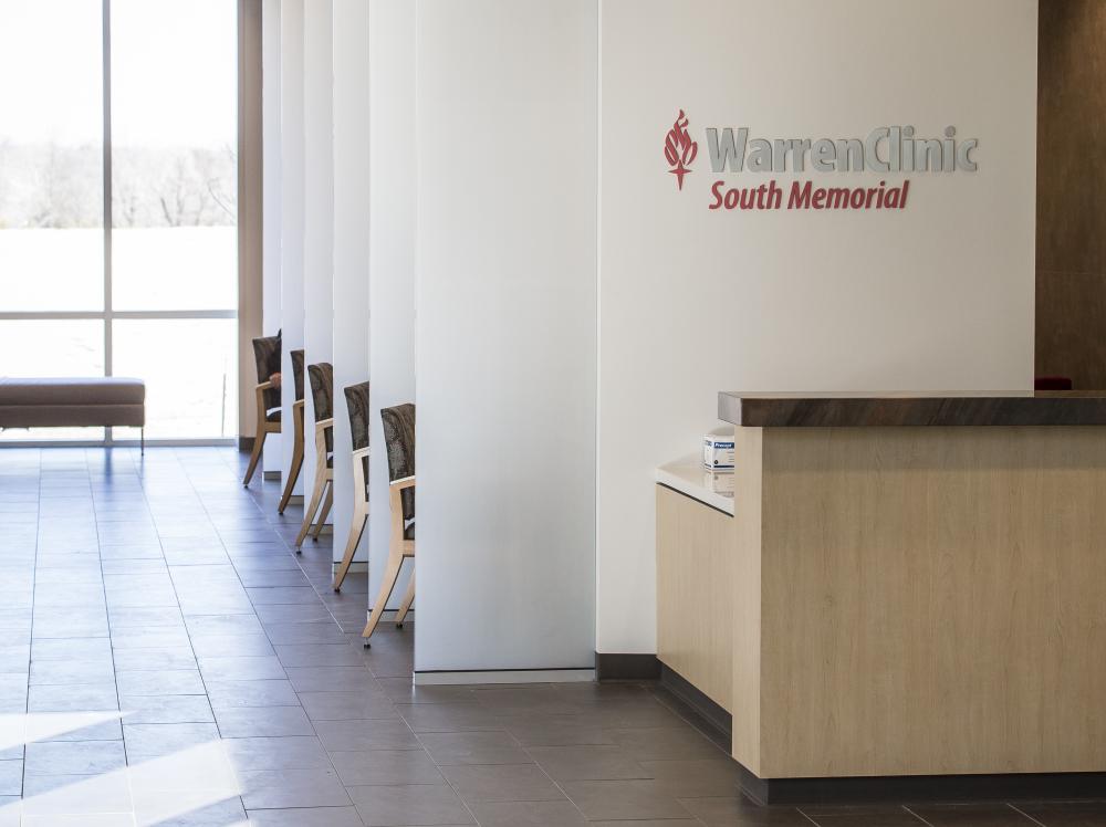 Interior view of Warren Clinic South Memorial front desk with lobby in background